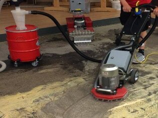 Floor grinder demonstration during subfloor preparation